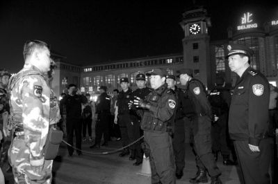 昨晚，傅政华在北京站与执勤武警交流。京华时报记者陶冉摄